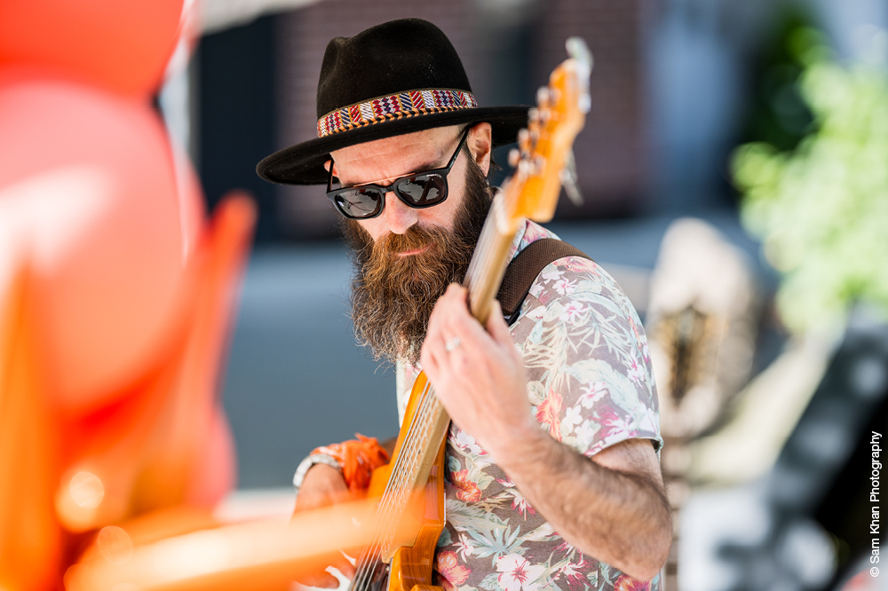 Musician wearing hat and sunglasses on a sunny day