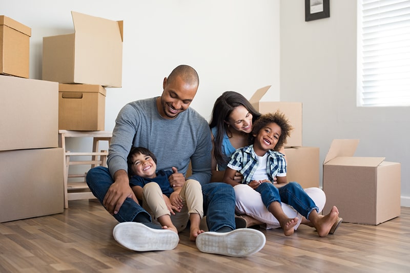 A family in a new home surrounded by boxes