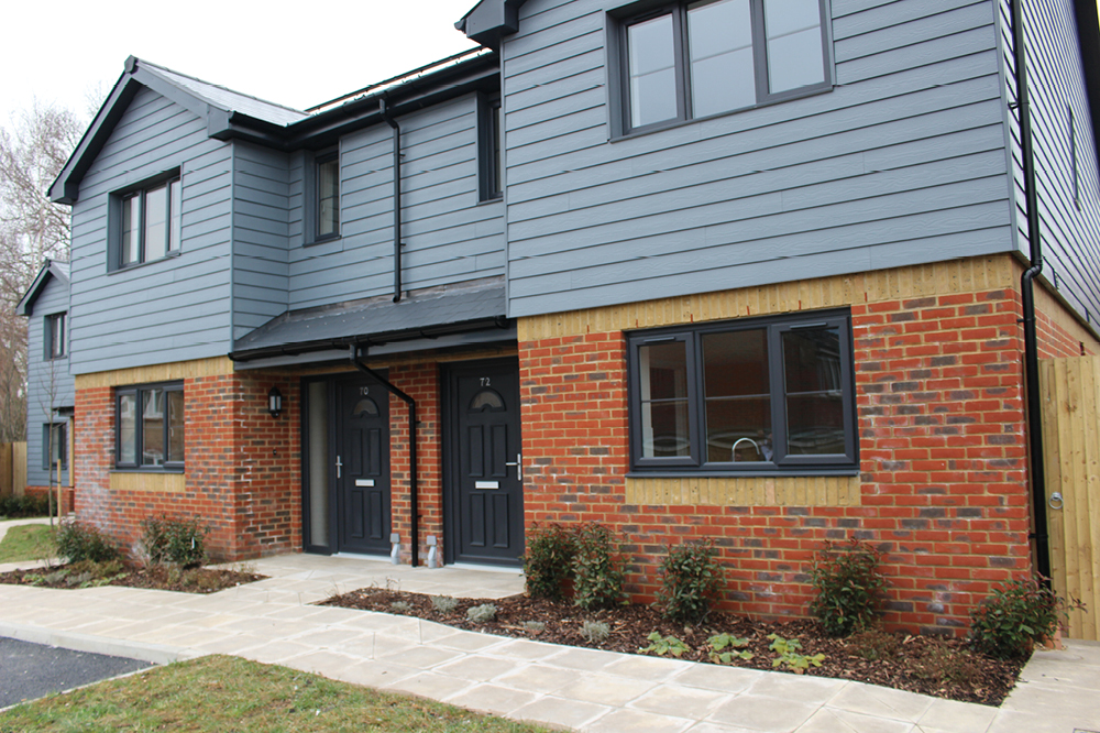 New family homes clad in contemporary dark grey wood panelling