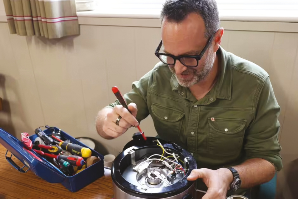 Shipley repair cafe volunteer repairing a slow cooker