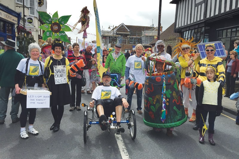 Members of Greening Steyning dress up in colourful costumes to raise awareness of climate issues. There are people dressed as bumble bees, flowers and a beekeeper