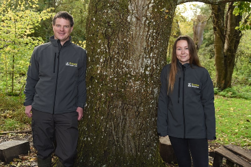 New members of the Wilder Horsham District Team stand either side of a tree