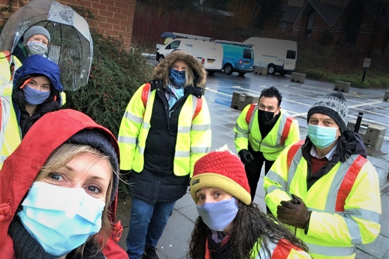 Volunteers in hi vis jackets and masks