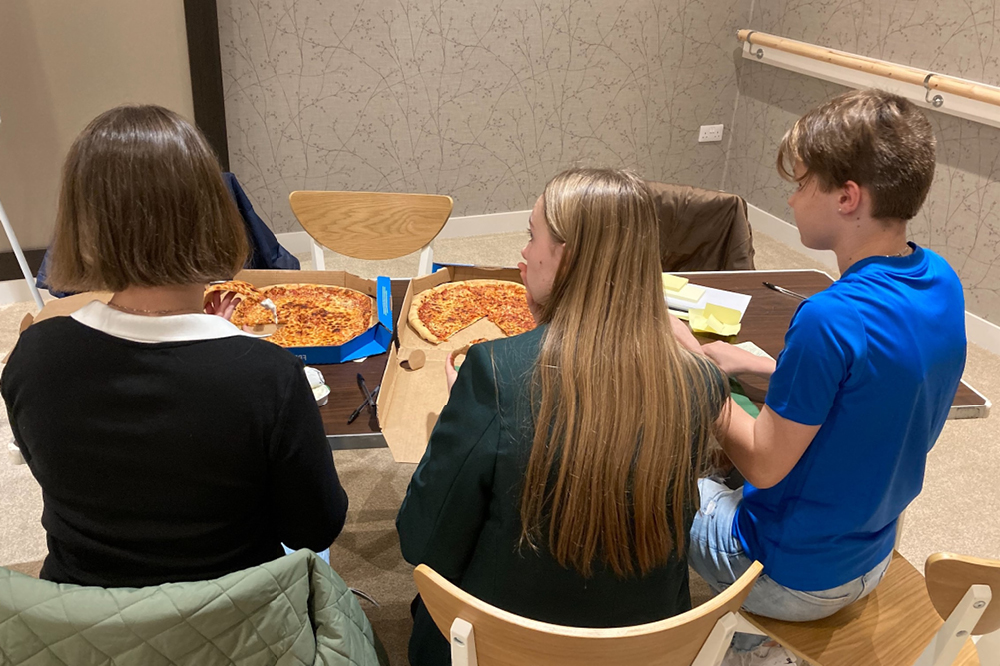 Youth Forum members at a meeting with pizza