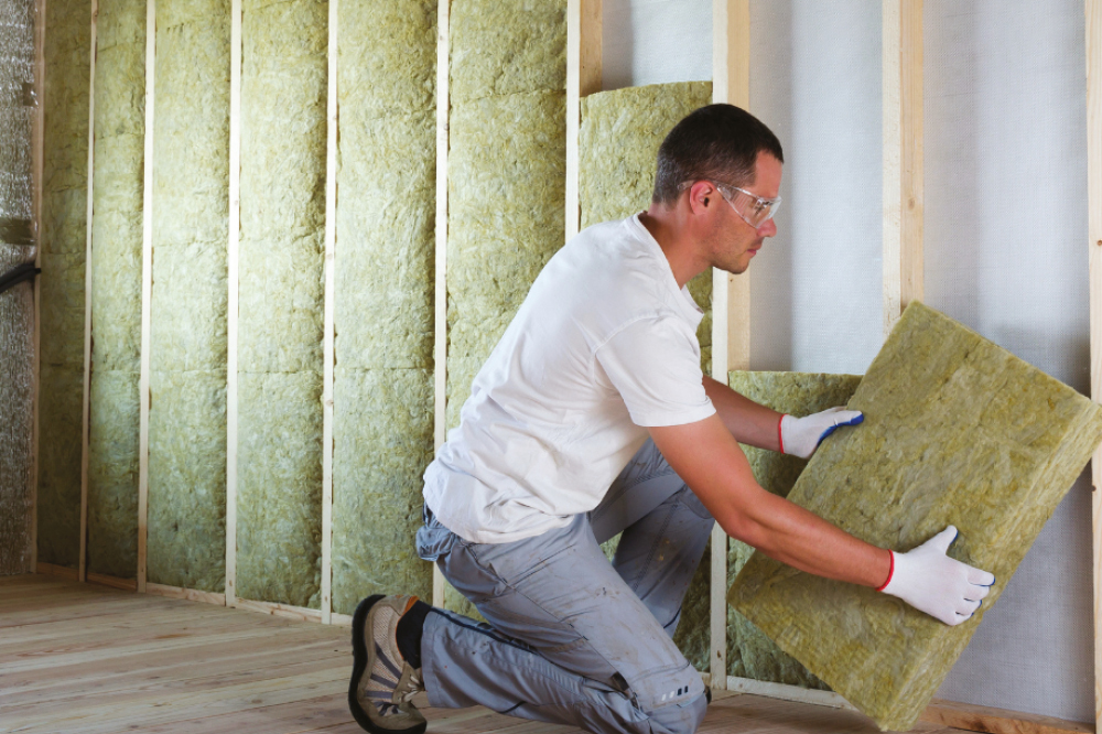 Man installing insulation