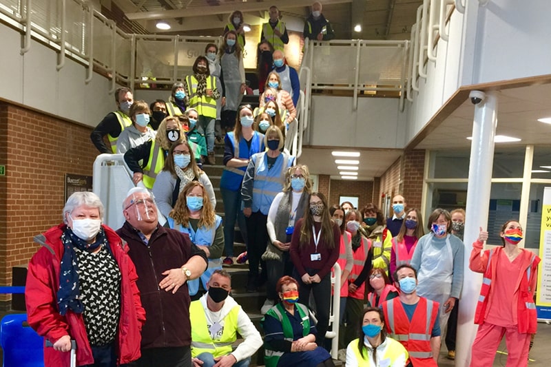 Large group of volunteers standing on the stairs