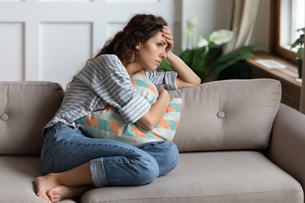 Woman sitting on a sofa looking worried