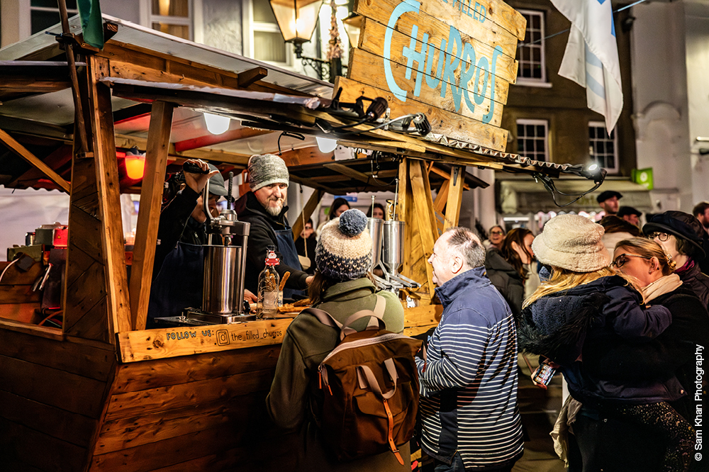 Christmas market stand selling churros