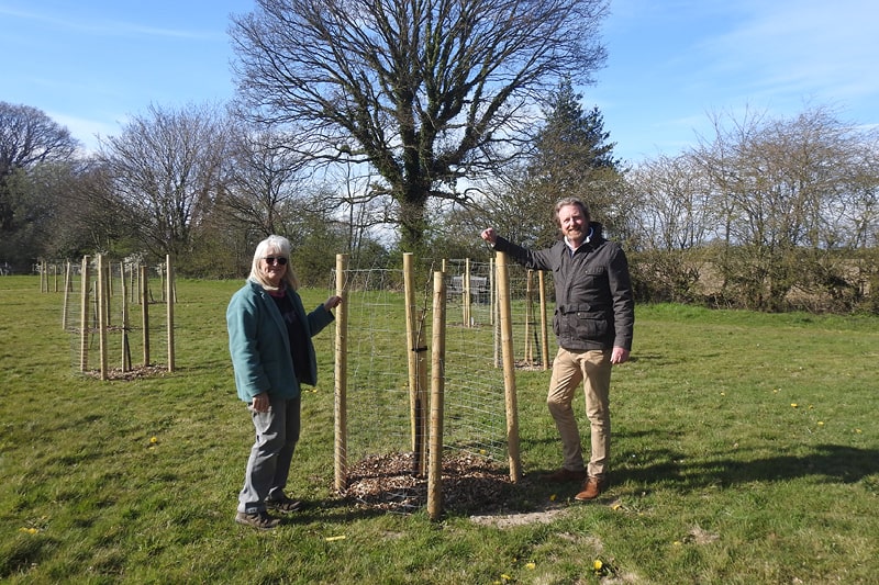 Two members of Friends of Glebe Field stand with their newly planted trees