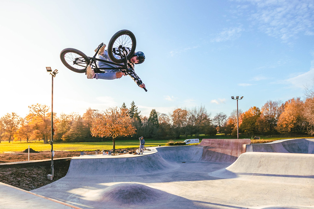 A BMX rider in the air at Horsham Park skatepark on a sunny day