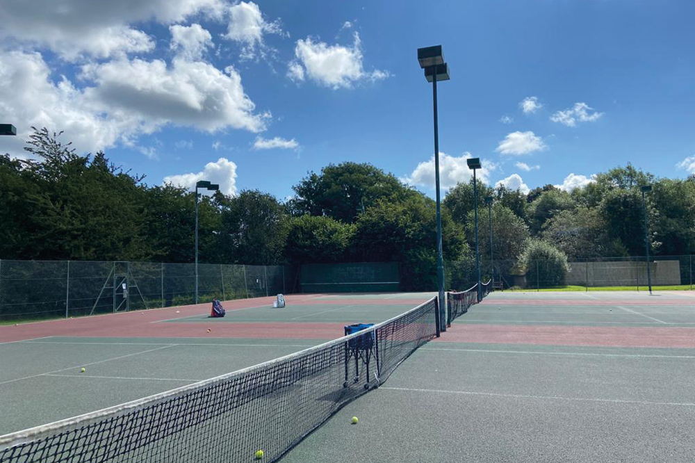 Tennis courts with tall floodlights