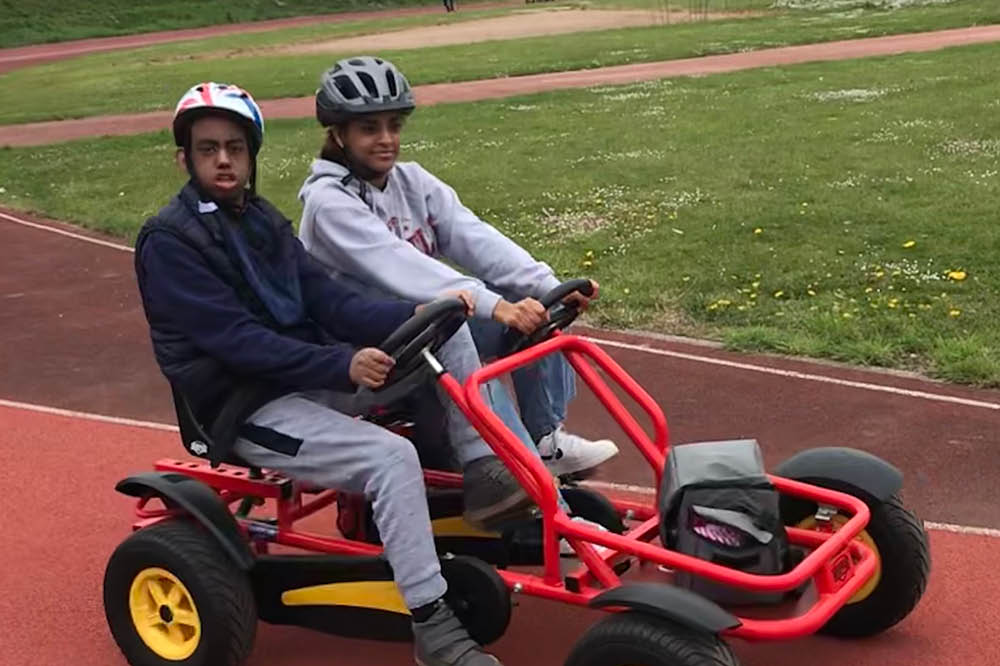 Alazar with his sister on a side by side tandem